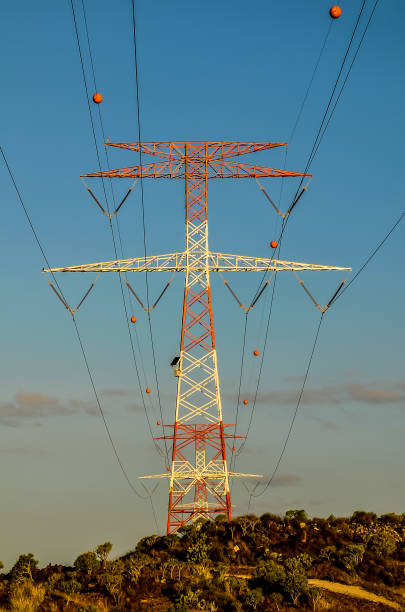 istock A tall power line tower with a white and red cross on top 2192705515