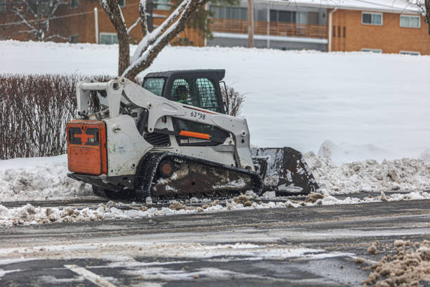 istock Small snowplow seen from the side/rear moving snow 2192706467