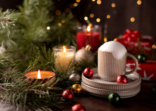 istock Festive Holiday Setting with Hot Drink and Candle Surrounded by Christmas Decor Featuring Pine Branches and Festive Ornaments for a Cozy Seasonal Ambiance 2192707776