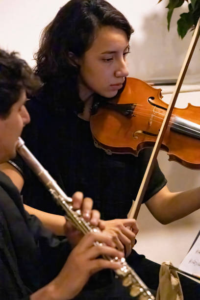 Violinist and flautist playing in the first act