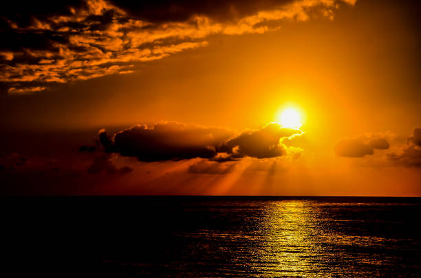 istock The sun is setting over the ocean, casting a warm glow on the water 2192712419