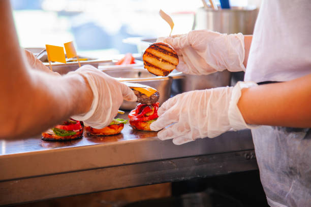 istock Assembly of Gourmet Cheeseburgers in a Professional Kitchen 2192715747