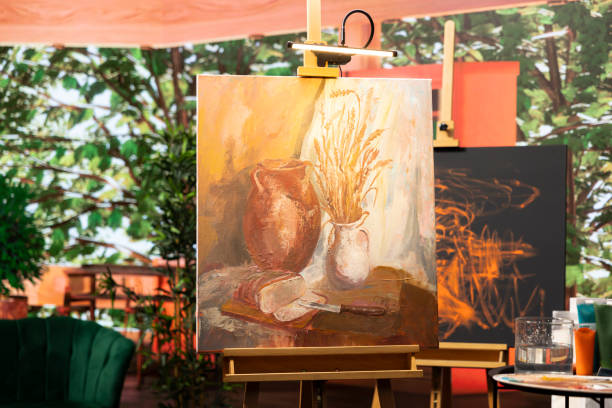 Empty artistic atelier with a rustic watercolor painting displayed on canvas, creative process with acrylic paint in a contemporary art and craft workshop. Masterpiece creation and supplies.