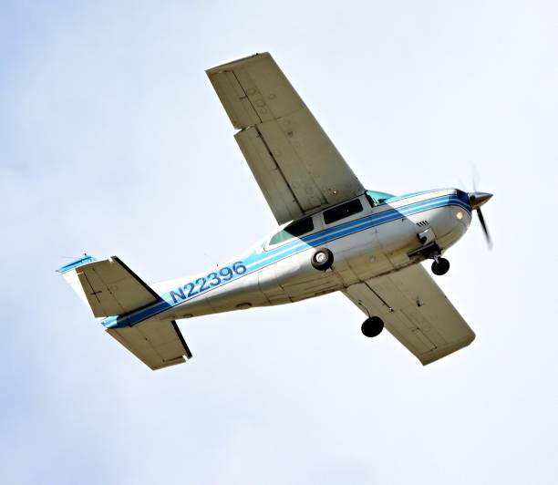 Netherlands, Groningen, Lauwersmeer, May18th 2023, close-up from directly below of a private Cessna 172 plane  flying over against a clear sky - the Cessna 172  is an American single-engine aircraft with 4 seats, it is built since 1955 by US \
