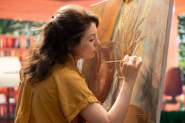 istock Inspired artist works on a canvas to create a masterpiece in atelier 2192723693