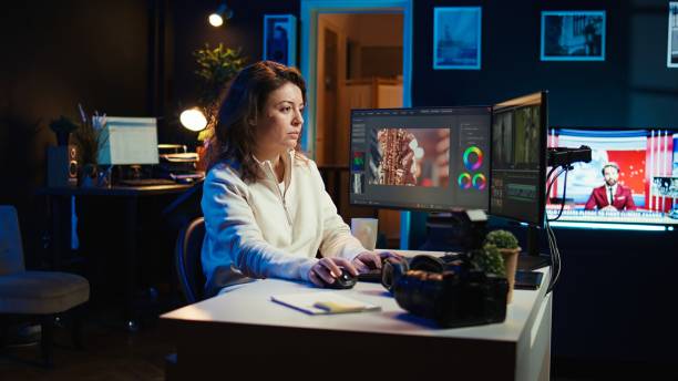 Cheerful woman using mouse to edit movie project footage in office Video editor selecting key frames to use while doing video montage, working from home on computer. Cheerful woman using mouse to edit movie project footage in office, camera B female film editor stock pictures, royalty-free photos & images