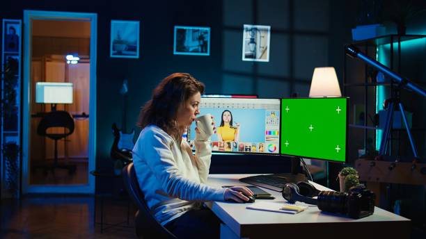 istock Content specialist making social media post on green screen PC 2192726131