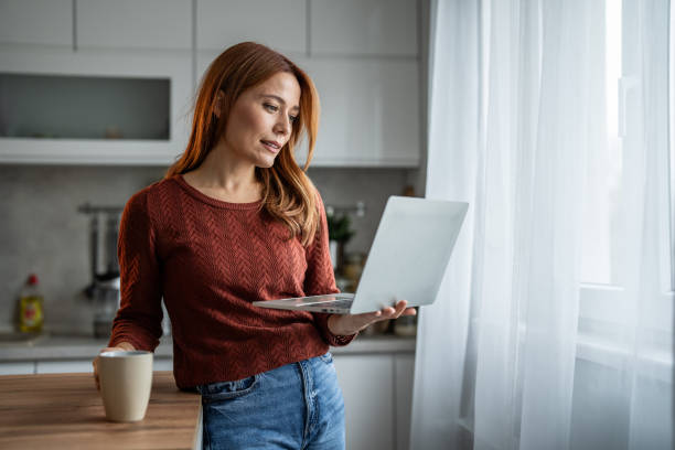 istock Woman enjoying her coffee while working on the laptop 2192727522