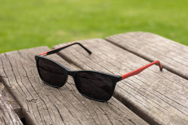 istock Black Sunglasses on Wooden Table with Sleek Contrast 2192727800