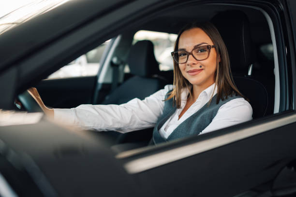 istock Businesswoman smiling while driving a car 2192729572