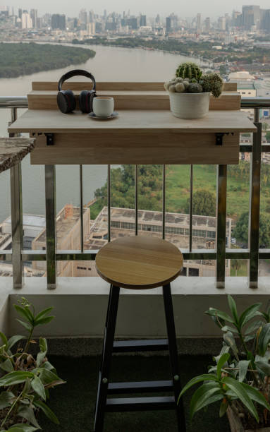 istock Decorated balcony with Adjustable balcony bar table and wooden chair. 2192729752