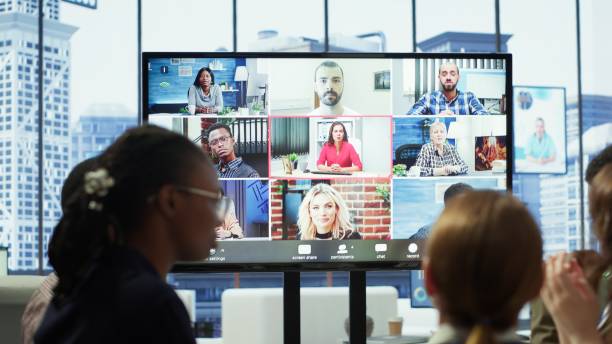 istock Diverse team of workers reviewing project updates together with shareholders 2192730849