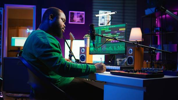 istock Skilled composer writing rhymes and lyrics to create new music in home studio 2192732482