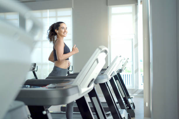 istock Hispanic woman is running on treadmill. 2192732744