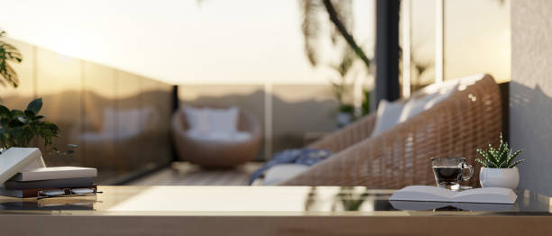 istock A coffee table features books, a coffee cup, and decorative plants on an apartment balcony. 2192742620