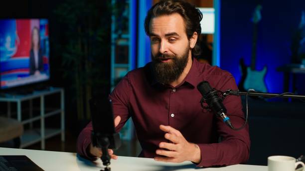 istock Man using microphone and mobile phone to film ASMR video 2192743520