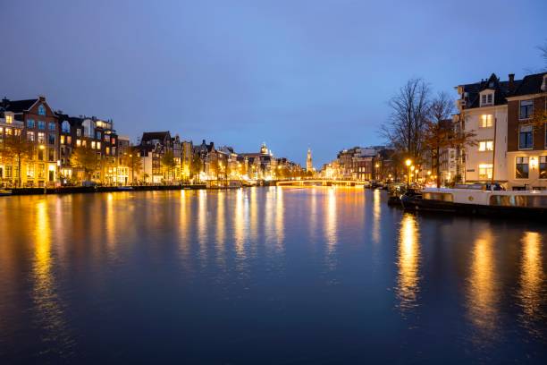 istock Canal in Amsterdam with illuminated buildings and reflection on the water 2192743674