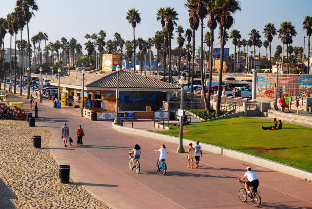 Huntington Beach, CA, USA September 25 People enjoy a sunny summer day biking and walking on the bike path near the coast in Huntington Beach, California