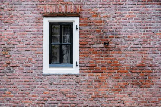 istock Facade view of window with curtain on brick wall background 2192746019