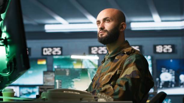 istock Officer using monitoring equipment in base of operations on enemy 2192746721