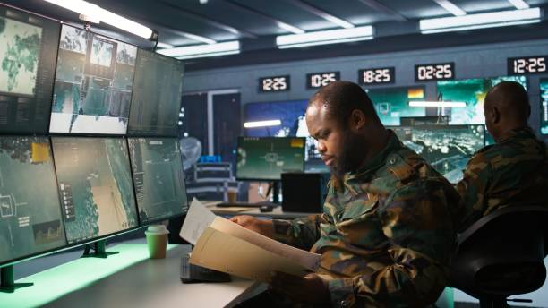 istock Army specialist overseeing national safety operations, reading folder files 2192748553