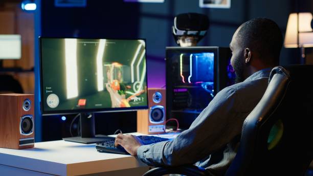 istock Man having fun by playing videogames on gaming PC at computer desk 2192748893