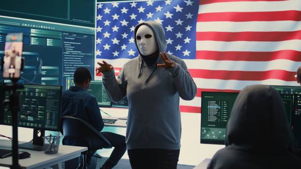 istock Person in anonymous mask working on intelligence in a governmental hacking room 2192749999