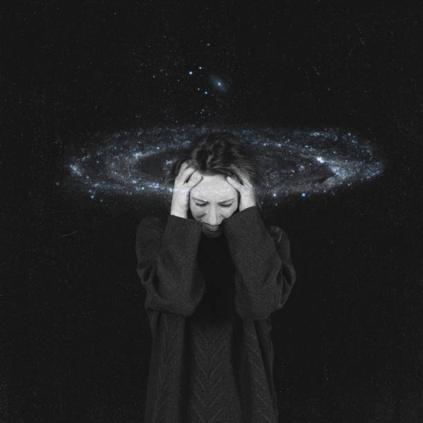 istock Woman holding hands on head while surrounded with galaxy 2192751977