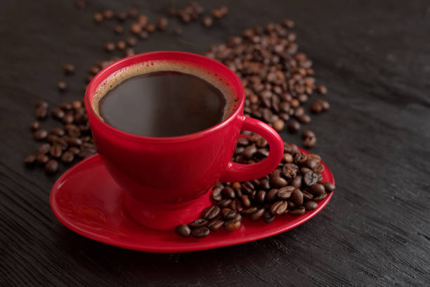 istock Cup of coffee on a saucer on a black background for breakfast 2192754486