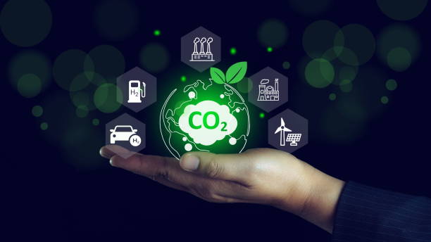 istock Energy saving, Sustainable development.Reduce CO2 emission concept. Hand-holding crystal globe with a CO2 icon and green business based on renewable energy. 2192755583