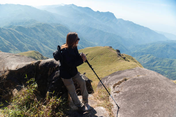 istock Hiker asian backpack walking trail activity camping outdoors and People exploring forest green natural capturing beauty nature outdoor. 2192755626