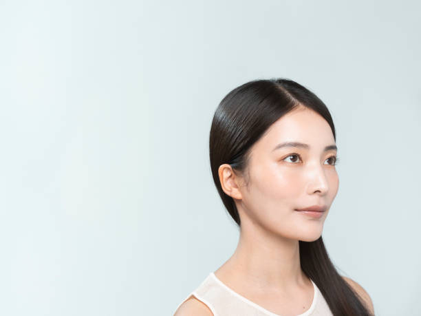istock A young black-haired Japanese woman doing hair care 2192757504