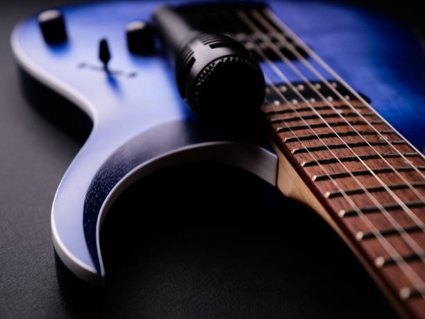 istock Microphone and electric guitar on a dark background. 2192758378