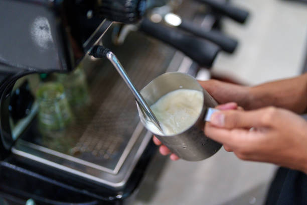 Barista Frothing Milk for Coffee