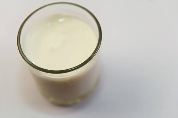 istock A glass of milk is sitting on a white table 2192758552