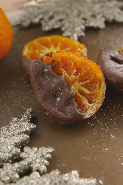istock candied tangerine oranges with chocolate, winter sweets 2192759163
