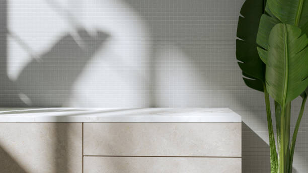 istock Realistic 3d render showing empty space on a marble countertop against the background of a wall covered with ceramic tiles. Shadows of the window and plants. Soft morning light. Stone kitchen fronts. 2192761519