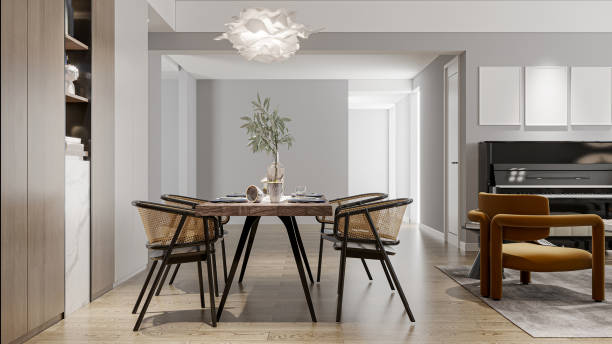 istock Minimalist dining room featuring a large wooden table and rustic chairs adjacent to the living room. 2192761673