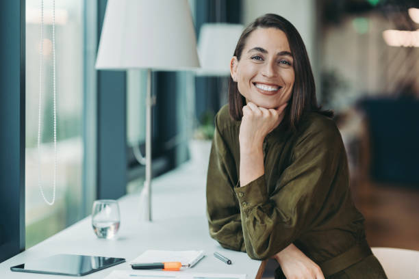 istock Cheerful businesswoman with textbook and digital tablet 2192762738