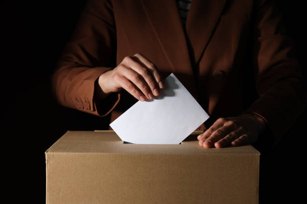istock Paper voting box with form and men on black background, close up 2192763348
