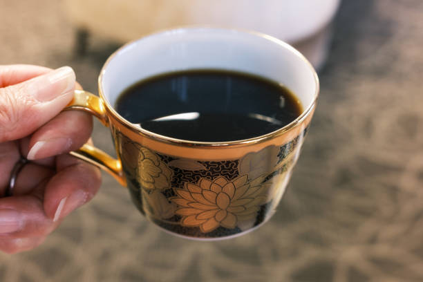 istock A woman’s hand holding a cup of coffee. 2192763643