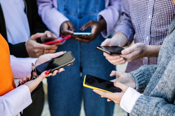 istock Young group of student friends using smart phone outdoors 2192765075