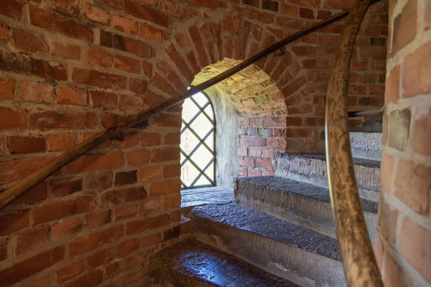 Stairs at a window niche in an old brick tower