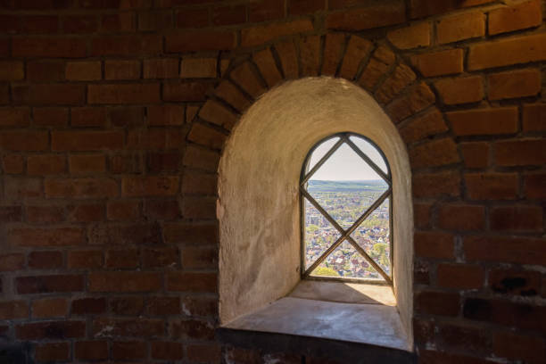 Window with a view in an old brick tower from the inside