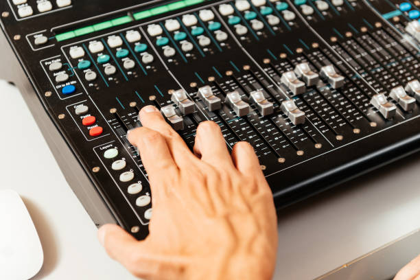 istock Close-up View of Male Hands Adjusting Mixer Controls in a Recording Studio Environment 2192765706