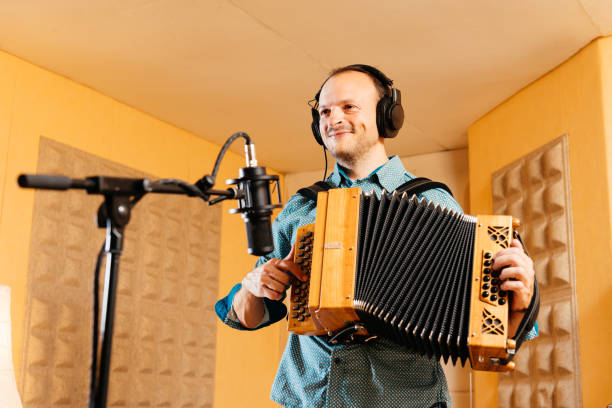 istock Smiling Diatonic accordion player records in a professional studio setting during a creative session 2192765770