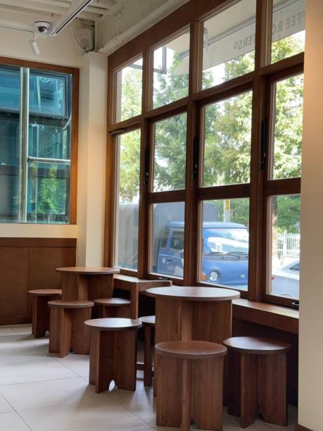 Cozy cafe interior with modern decor, comfortable seating, and warm lighting. A perfect spot for enjoying coffee or tea, creating a relaxed and inviting atmosphere for guests.