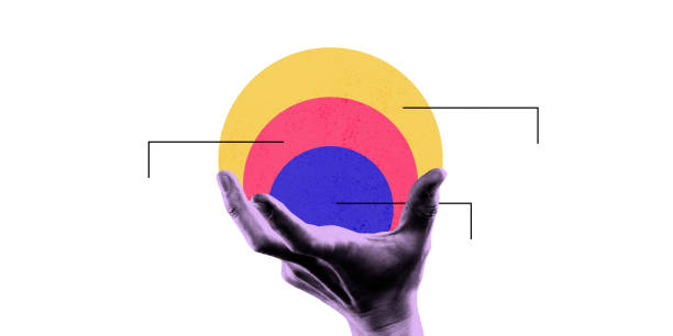 hand holding concentric colorful circles with lines pointing to them, representing focus, strategy, and layered approach in business and analytics.