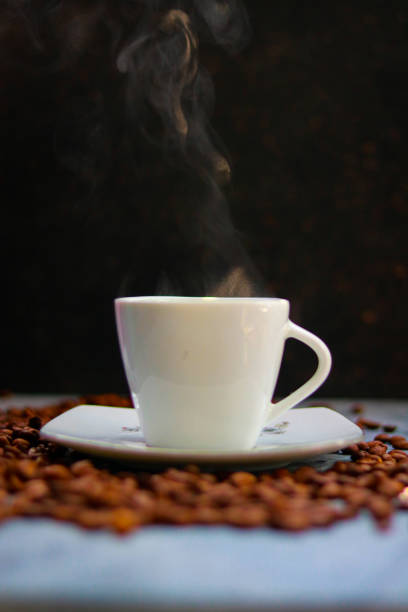 Coffee cup and coffee beans on black background, stock photo