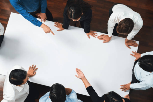 istock Businesspeople on meeting table pointing to empty space. Prudent 2192777376